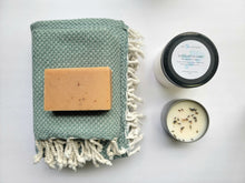 Load image into Gallery viewer, Dusty teal set of Turkish bath and hand towels with tassels, a bar of soap, a eucalyptus mint bath salts, and a lavender sage candle on a white background.
