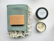 Load image into Gallery viewer, Dusty teal set of Turkish bath and hand towels with tassels, a bar of soap, a eucalyptus mint bath salts, and a lavender sage candle on a white background.