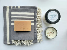 Load image into Gallery viewer, Slate gray set of Turkish bath and hand towels with tassels, a bar of soap, a eucalyptus mint bath salts, and a lavender sage candle on a white background.